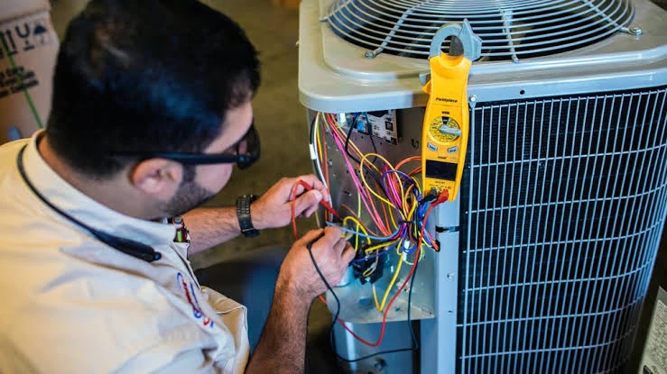 Close-up of HVAC electrical diagnostics with a clamp meter
